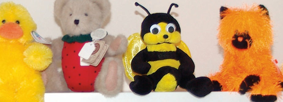 Plush Bee sitting among Danny’s other stuffed friends