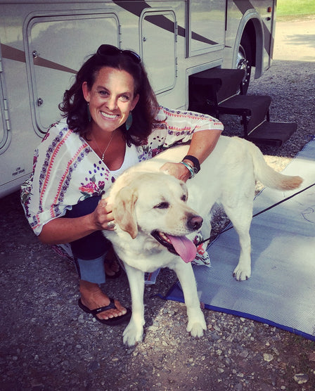 Amy Musser holding Norman the yellow Labrador puppy